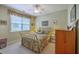 Cozy bedroom with floral bedding, a ceiling fan, a wooden dresser, and natural light from the window at 1207 Rivers Reach Dr, Wando, SC 29492