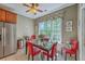 Charming breakfast nook featuring a glass table, red chairs, and natural light from the large window at 1207 Rivers Reach Dr, Wando, SC 29492