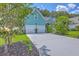 Charming two-story home with a two car garage, blue siding, and well-manicured landscaping at 1207 Rivers Reach Dr, Wando, SC 29492