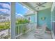 Inviting front porch with chairs and a view of the neighborhood and beautiful green trees at 1207 Rivers Reach Dr, Wando, SC 29492