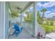 Comfortable front porch with blue Adirondack chairs and a view of the manicured green lawn at 1207 Rivers Reach Dr, Wando, SC 29492