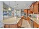 Gourmet kitchen with granite counters, wood cabinets, and stainless steel appliances offers a kitchen island at 1207 Rivers Reach Dr, Wando, SC 29492