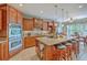 Kitchen featuring an island with seating, stainless steel appliances, and custom wood cabinetry at 1207 Rivers Reach Dr, Wando, SC 29492