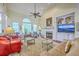 Bright living room featuring a fireplace, built-ins, large windows, and comfortable seating at 1207 Rivers Reach Dr, Wando, SC 29492