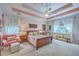 Spacious main bedroom featuring a tray ceiling, comfortable seating, and natural light at 1207 Rivers Reach Dr, Wando, SC 29492