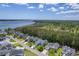 Aerial view of a residential neighborhood with well-maintained homes, tree-lined streets, and waterway access at 1207 Rivers Reach Dr, Wando, SC 29492