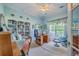 Home office with built-in bookshelves, a desk, comfortable seating, and natural light from multiple windows at 1207 Rivers Reach Dr, Wando, SC 29492