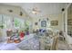 Sunroom with high ceilings featuring multiple windows, tile floors, ceiling fan, and comfortable seating at 1207 Rivers Reach Dr, Wando, SC 29492