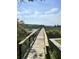 Wooden bridge extending through the marsh with a distant gazebo and beautiful blue skies at 1207 Rivers Reach Dr, Wando, SC 29492