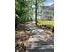 Wooden path leading towards the house with a green lawn and tall trees surrounding the area at 1207 Rivers Reach Dr, Wando, SC 29492