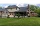 Lush backyard with a screened porch, beautiful landscaping, and a manicured lawn at 122 Hidden Fawn Cir, Goose Creek, SC 29445