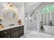 Modern bathroom with soaking tub, walk-in shower, updated vanity, marble countertops, and stylish gold fixtures at 122 Hidden Fawn Cir, Goose Creek, SC 29445