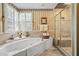 Elegant bathroom showcasing a luxurious tub, separate shower, and classic finishes at 122 Hidden Fawn Cir, Goose Creek, SC 29445