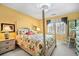 Comfortable bedroom with a four poster bed, floral bedding, and a cozy rocking chair near bright windows at 122 Hidden Fawn Cir, Goose Creek, SC 29445