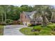 Charming home showcasing a well-kept lawn, brick exterior, and mature trees at 122 Hidden Fawn Cir, Goose Creek, SC 29445