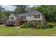 Well-maintained two-story home with a brick facade, manicured landscaping, and mature trees at 122 Hidden Fawn Cir, Goose Creek, SC 29445