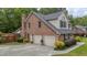 Two-story home featuring a brick facade, well-manicured landscaping, and an attached two-car garage at 122 Hidden Fawn Cir, Goose Creek, SC 29445