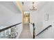 Elegant two-story hallway with a chandelier and stairway leading to the living area at 122 Hidden Fawn Cir, Goose Creek, SC 29445