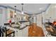 Open kitchen featuring granite countertops, island seating, stainless appliances, and hardwood floors at 122 Hidden Fawn Cir, Goose Creek, SC 29445