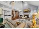 A cozy living room with a fireplace, plush seating, tall ceilings, and ample natural light at 122 Hidden Fawn Cir, Goose Creek, SC 29445