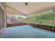 A screened porch with a blue carpet provides a view of the green backyard and trees at 122 Hidden Fawn Cir, Goose Creek, SC 29445