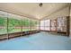 Enclosed screened porch with blue flooring and a view of the grassy backyard at 122 Hidden Fawn Cir, Goose Creek, SC 29445