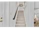 Carpeted staircase with white walls, dark wooden handrail, and decorative hardware at 122 Hidden Fawn Cir, Goose Creek, SC 29445