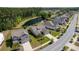 Aerial view of a home situated next to a pond in a neighborhood with mature trees at 1245 Hammrick Ln, Johns Island, SC 29455