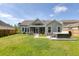 Backyard view features a fenced-in yard, patio, hot tub, and wooded backdrop at 1245 Hammrick Ln, Johns Island, SC 29455