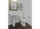 Powder room with a pedestal sink, framed mirror, and stylish shelving at 1245 Hammrick Ln, Johns Island, SC 29455