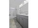 A bathroom featuring a double vanity, quartz countertops, and a shower-tub combo with neutral tile at 1245 Hammrick Ln, Johns Island, SC 29455