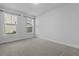 Bright bedroom featuring neutral carpet, two large windows offering natural light and backyard views at 1245 Hammrick Ln, Johns Island, SC 29455