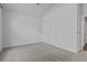 Bright bedroom featuring neutral carpet, a large window, and double doors at 1245 Hammrick Ln, Johns Island, SC 29455