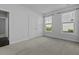 Bright bedroom featuring neutral carpet, two large windows and a double door closet at 1245 Hammrick Ln, Johns Island, SC 29455