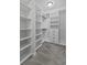 Spacious closet with neutral carpet and custom shelving offers ample storage space and organization at 1245 Hammrick Ln, Johns Island, SC 29455