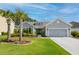 Charming single-story home with a well-manicured lawn, inviting curb appeal, and attached two car garage at 1245 Hammrick Ln, Johns Island, SC 29455