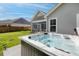 Backyard view of a bubbling hot tub with a screen porch and a privacy fence at 1245 Hammrick Ln, Johns Island, SC 29455