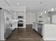 Open kitchen with stainless steel appliances, gray cabinets, and dark wood flooring at 1245 Hammrick Ln, Johns Island, SC 29455
