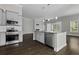 Gourmet kitchen with island, stainless appliances, granite countertop, and dark hardwood floors at 1245 Hammrick Ln, Johns Island, SC 29455