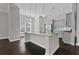 Modern kitchen island with stainless steel appliances, hardwood floors, and a breakfast bar at 1245 Hammrick Ln, Johns Island, SC 29455