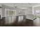 Bright living room with hardwood floors, ceiling fan, kitchen island, and sliding glass doors to the backyard at 1245 Hammrick Ln, Johns Island, SC 29455
