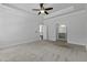 Large main bedroom features tray ceiling, fan, carpet flooring, and ensuite bathroom at 1245 Hammrick Ln, Johns Island, SC 29455