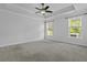 Spacious main bedroom featuring tray ceilings, fan, carpet flooring, and natural lighting at 1245 Hammrick Ln, Johns Island, SC 29455