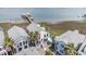 Aerial view of waterfront homes, a dock, and a private pool, showcasing the coastal lifestyle and amenities at 126 W 2Nd St, Folly Beach, SC 29439