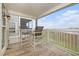 Charming outdoor seating on a covered balcony with views of the marsh and harbor at 126 W 2Nd St, Folly Beach, SC 29439