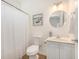Clean bathroom with a shower curtain, vanity, and a decorative mirror at 126 W 2Nd St, Folly Beach, SC 29439