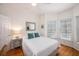 Comfortable bedroom with a queen bed, white linens, and natural light from multiple windows at 126 W 2Nd St, Folly Beach, SC 29439