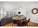 Open-concept dining area with wooden table, seating for four, and a view of the balcony at 126 W 2Nd St, Folly Beach, SC 29439
