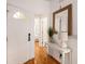 Entryway with a white door, wooden floors, console table, and a decorative mirror at 126 W 2Nd St, Folly Beach, SC 29439