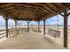 Wooden gazebo featuring a swing, benches, and views of the waterfront, providing a perfect spot for relaxation at 126 W 2Nd St, Folly Beach, SC 29439